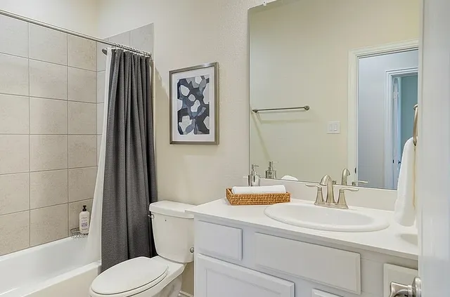 a bathroom with a sink toilet and shower