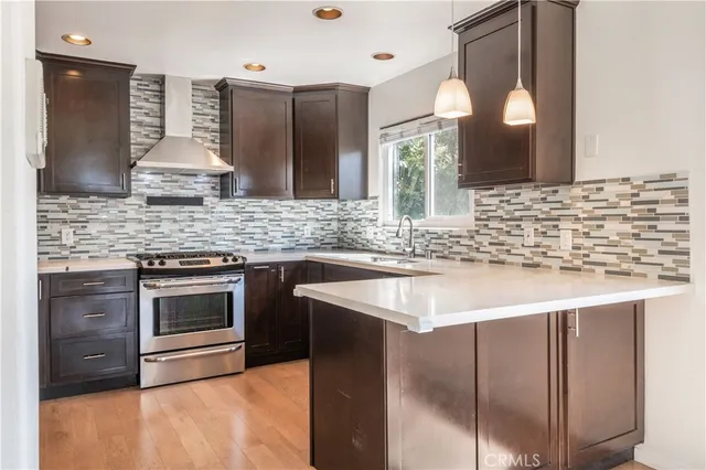 a kitchen with stainless steel appliances kitchen island granite countertop a sink and a stove