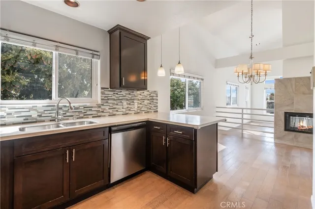 a kitchen with stainless steel appliances granite countertop a sink and wooden cabinets
