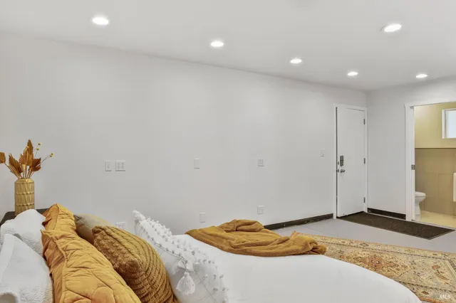 a bedroom with a bed and a couch