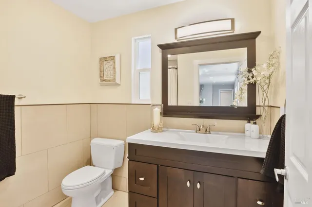 a bathroom with a toilet a sink and a mirror