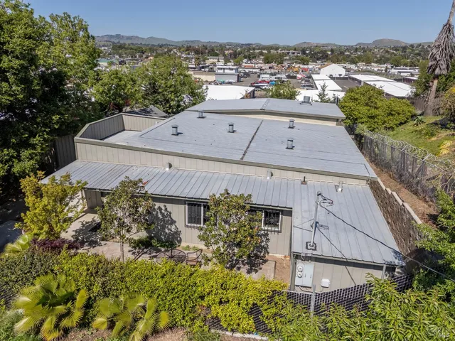 an aerial view of a house with a yard
