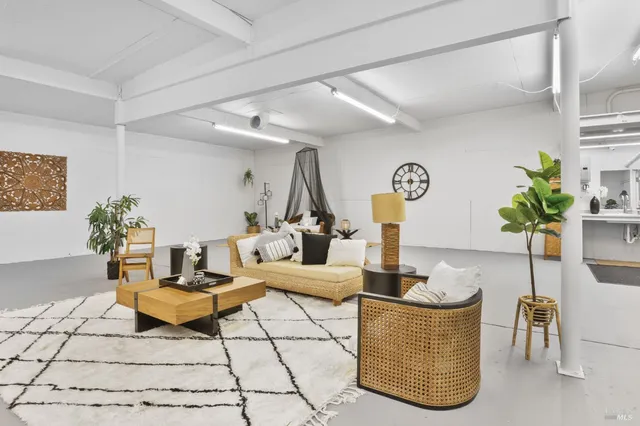 a living room with furniture and flowers