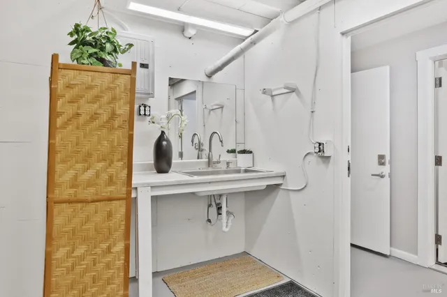 a bathroom with a sink a mirror and shower