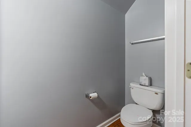 a white toilet sitting next to a bathroom sink