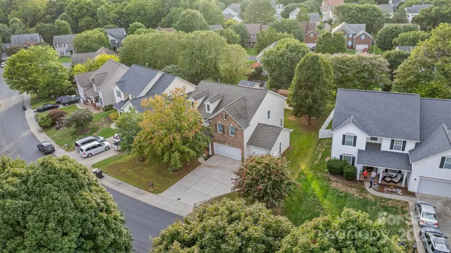 an aerial view of multiple houses with yard