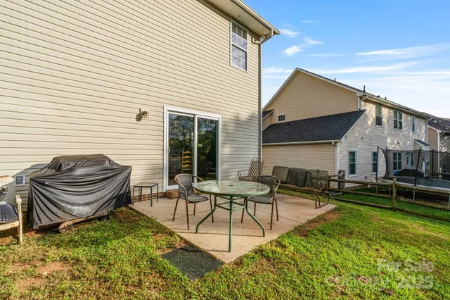a view of a house with backyard and sitting area