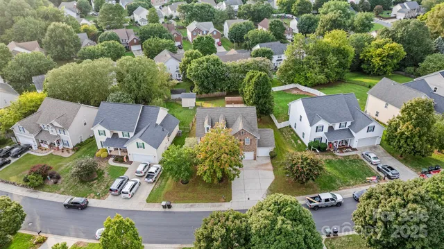 an aerial view of a house with swimming pool outdoor seating and yard