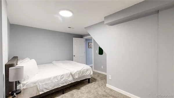 a bedroom with a bed and a night stand
