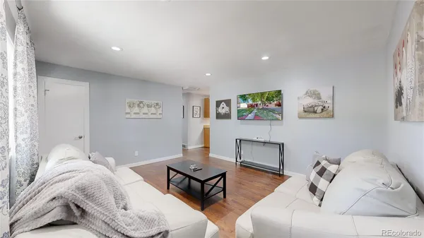 a bedroom with furniture and a wooden floor