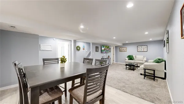 a view of a dining room with furniture and wooden floor