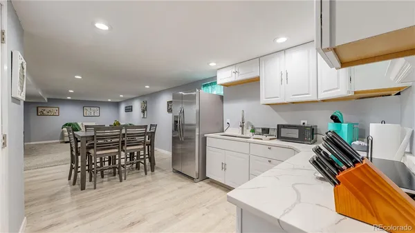 a kitchen with stainless steel appliances kitchen island granite countertop a sink and cabinets