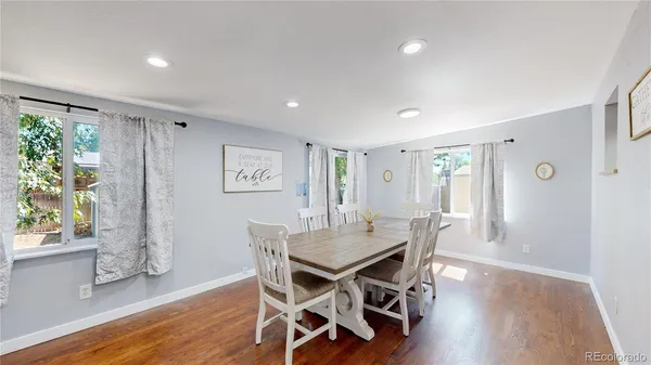 a view of a dining room with furniture and wooden floor