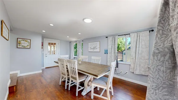 a view of a dining room with furniture and wooden floor