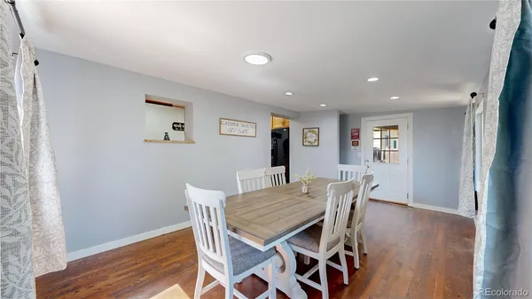 a view of a dining room with furniture and wooden floor