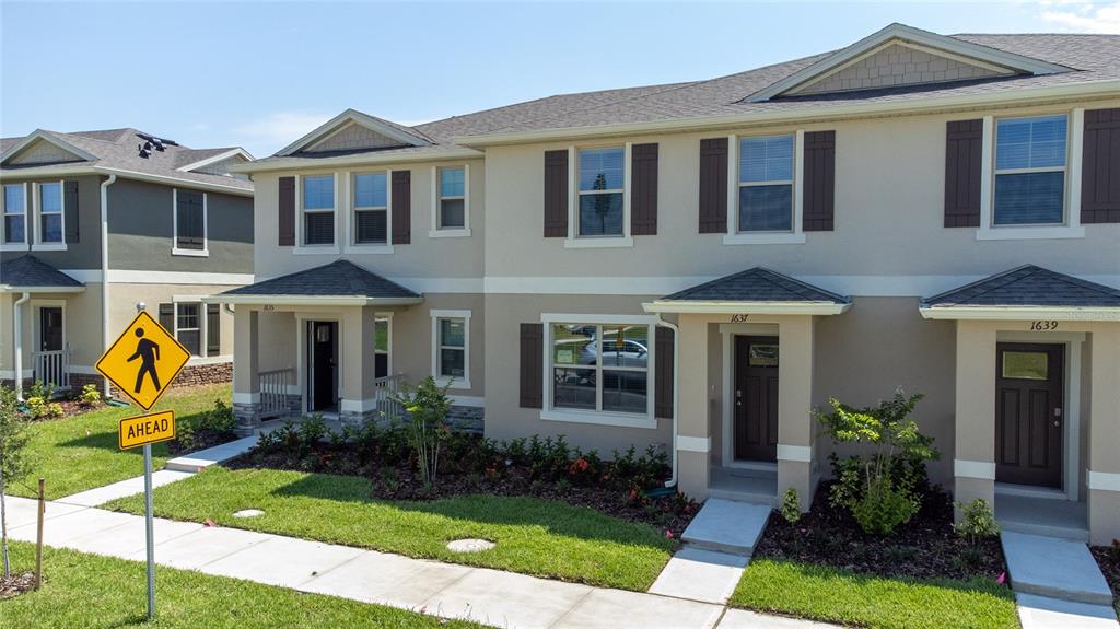 1637 Bitterroot Street Kissimmee, FL 34744 - Photo 1 of 1 a front view of a house with garden
