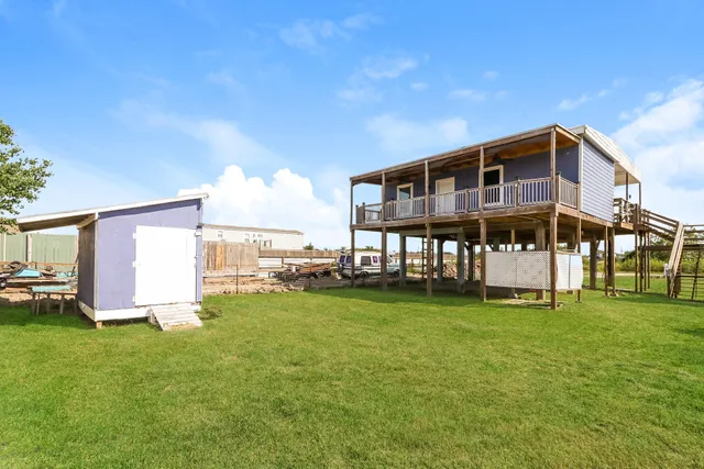 a front view of a house with a yard table and chairs