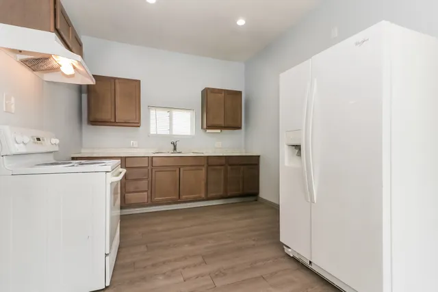 a kitchen with a sink a counter top space and cabinets