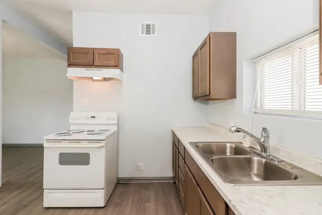 a kitchen with a sink and a stove top oven