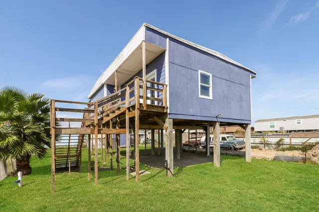 a view of a house with a yard and sitting area