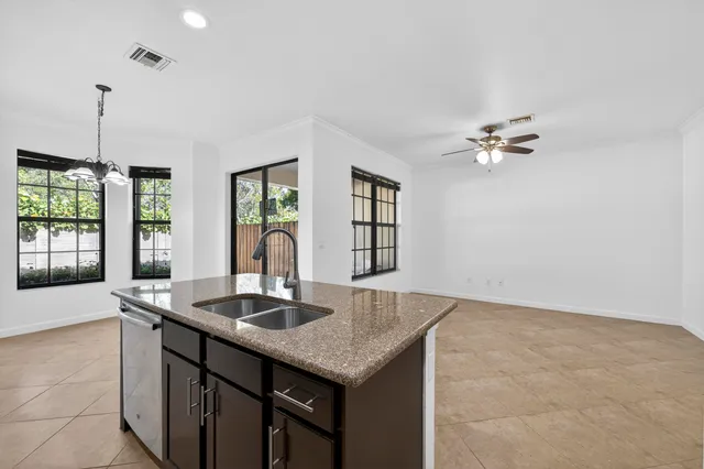 a kitchen with stainless steel appliances granite countertop a refrigerator stove top oven and sink