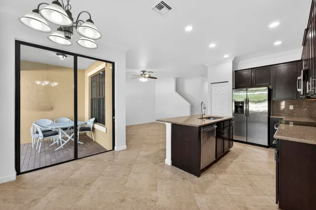 a kitchen with stainless steel appliances granite countertop a sink stove and cabinets