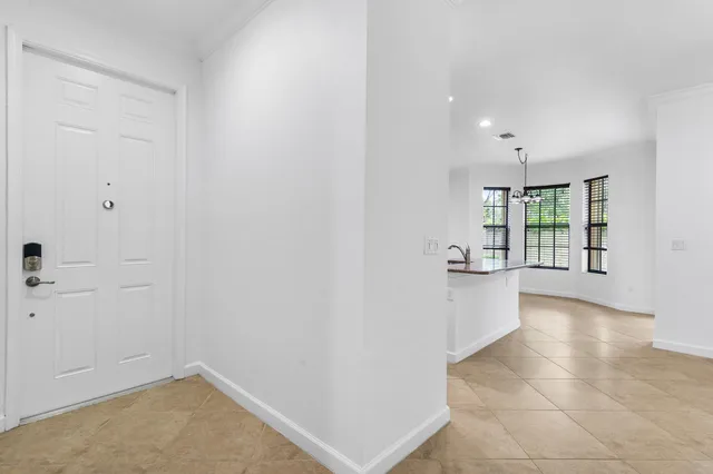 a large kitchen with stainless steel appliances a large counter top and a stove top oven