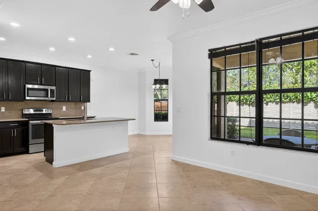 a view of kitchen with refrigerator and microwave