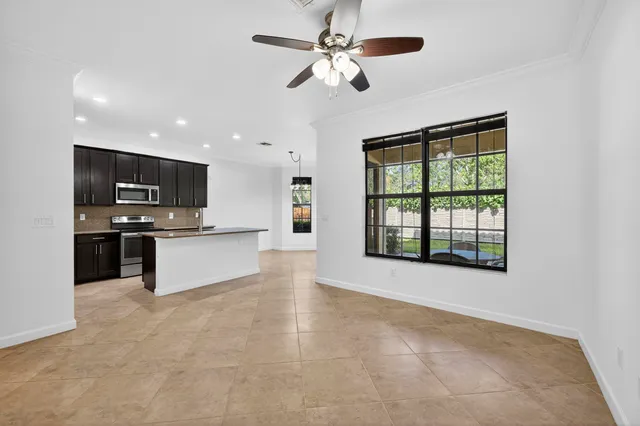 a kitchen with stainless steel appliances granite countertop a sink and a stove