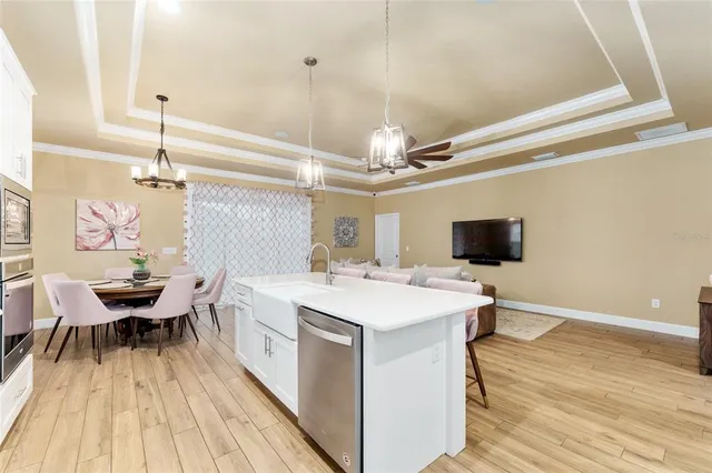 a large white kitchen with a stove and a refrigerator