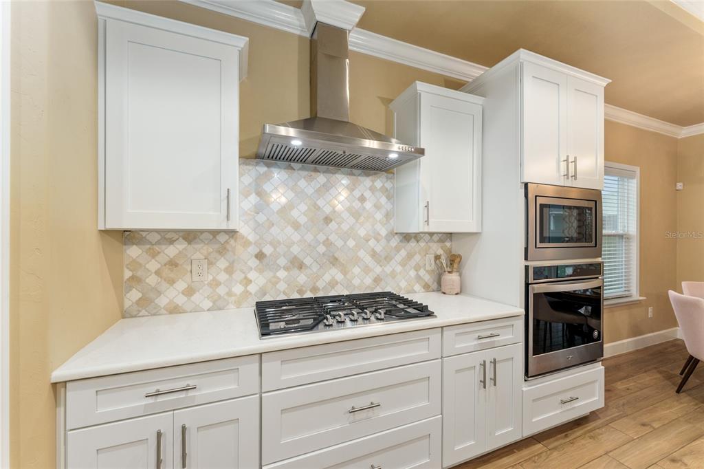 1788 Southwest 67th Circle Gainesville, FL 32607 - Photo 14 of 49 a kitchen with white cabinets and appliances