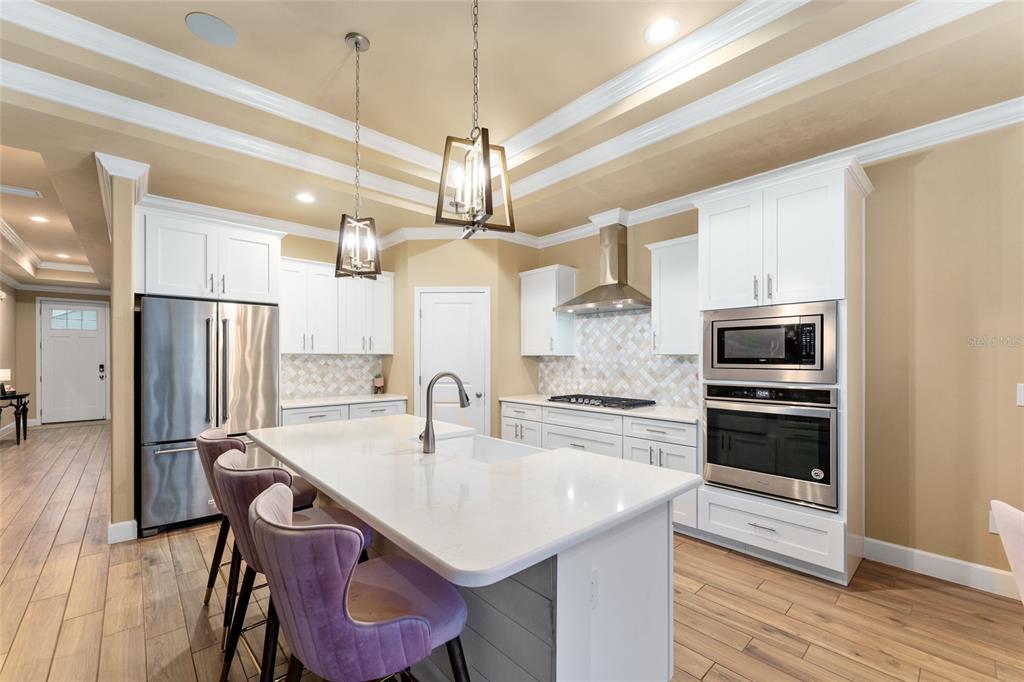 1788 Southwest 67th Circle Gainesville, FL 32607 - Photo 15 of 49 a kitchen with a center island and stainless steel appliances