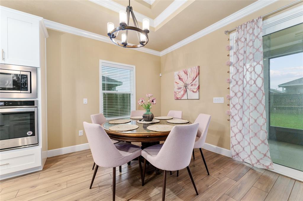 1788 Southwest 67th Circle Gainesville, FL 32607 - Photo 19 of 49 a dining room with furniture a chandelier and wooden floor