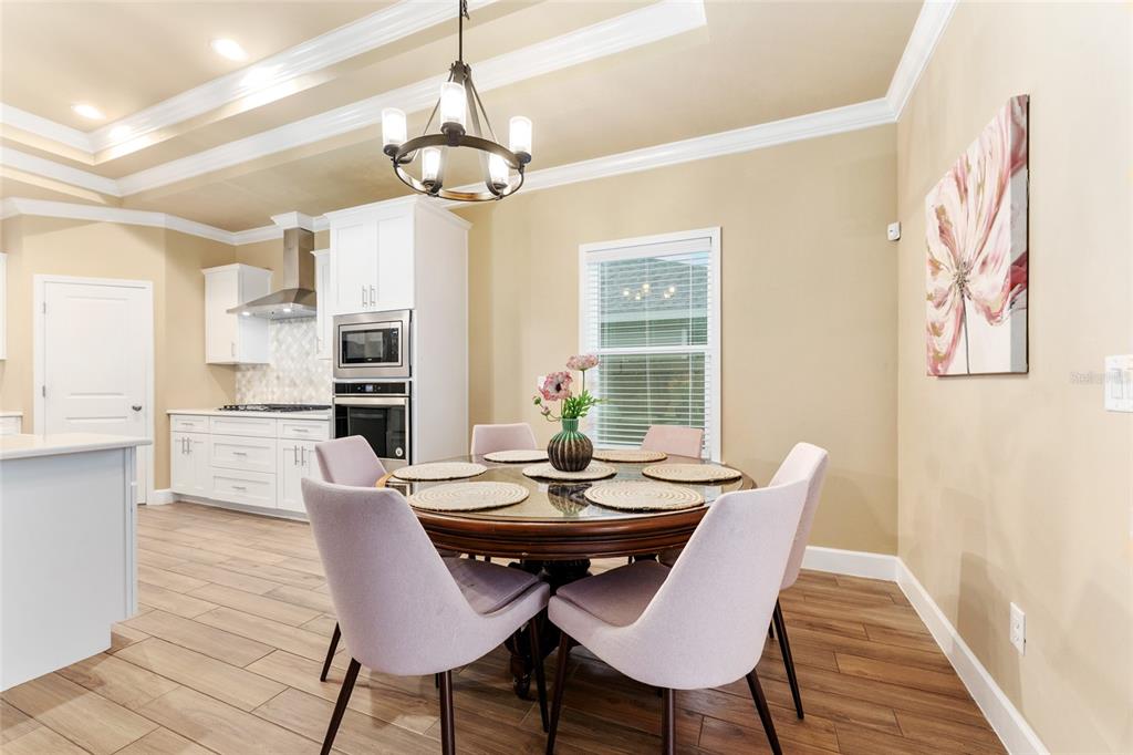 1788 Southwest 67th Circle Gainesville, FL 32607 - Photo 20 of 49 a view of a dining room with furniture and wooden floor