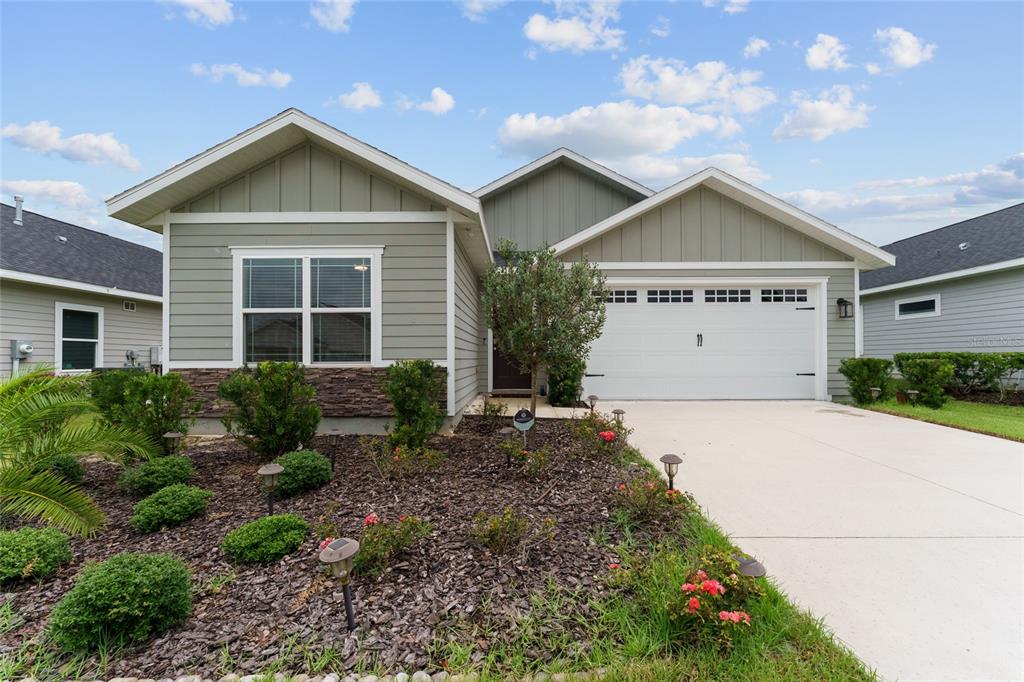 1788 Southwest 67th Circle Gainesville, FL 32607 - Photo 2 of 49 a front view of a house with a yard and garage