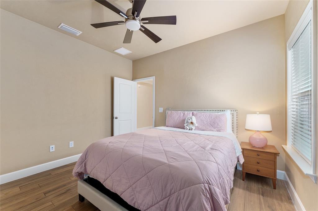 1788 Southwest 67th Circle Gainesville, FL 32607 - Photo 27 of 49 a bedroom with a bed and a chandelier