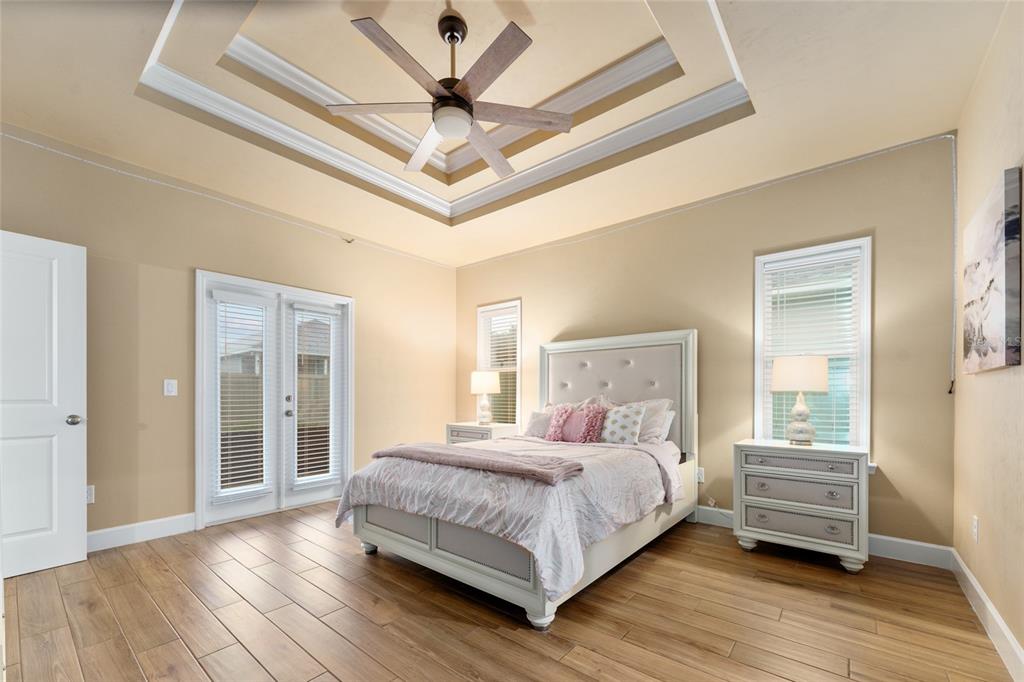 1788 Southwest 67th Circle Gainesville, FL 32607 - Photo 32 of 49 a bedroom with a large bed chandelier and a window