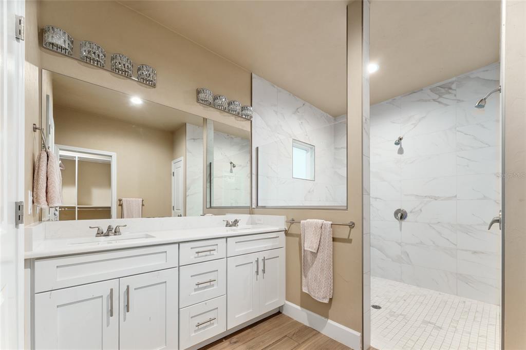 1788 Southwest 67th Circle Gainesville, FL 32607 - Photo 36 of 49 a bathroom with a double vanity sink mirror and shower