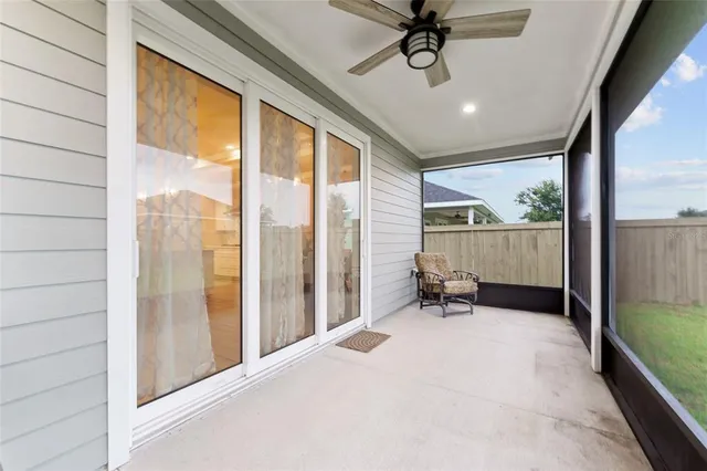 a view of a porch with furniture and a yard