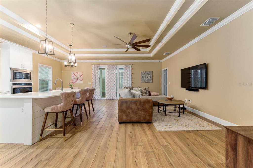 1788 Southwest 67th Circle Gainesville, FL 32607 - Photo 7 of 49 a living room with furniture a flat screen tv and a table