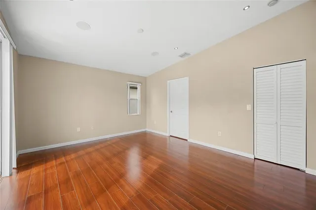 a view of an house with backyard and trees