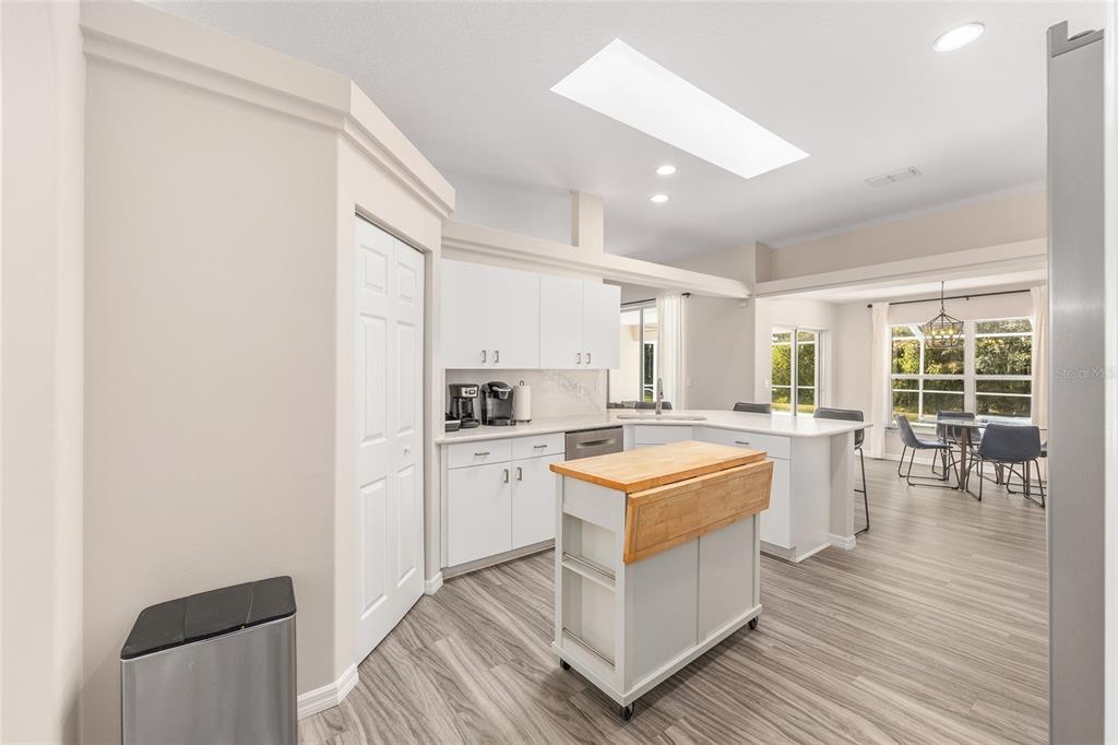 5248 Northwest 82nd Court Ocala, FL 34482 - Photo 19 of 73 a kitchen with a sink a stove a refrigerator and white cabinets