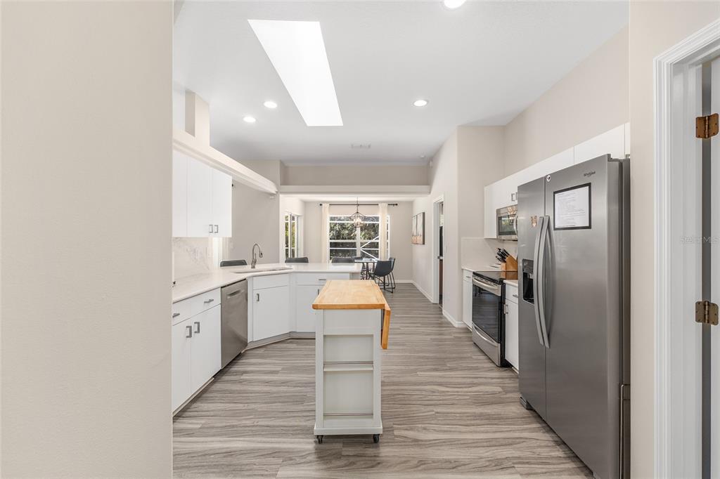 5248 Northwest 82nd Court Ocala, FL 34482 - Photo 20 of 73 a large kitchen with a lot of counter space and wooden floor