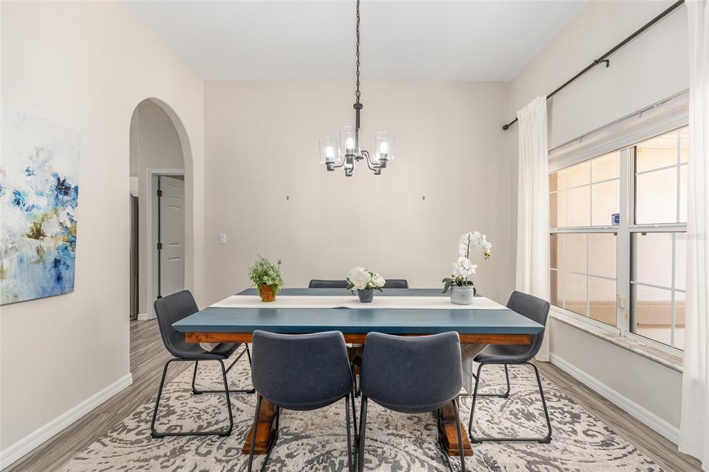 5248 Northwest 82nd Court Ocala, FL 34482 - Photo 26 of 73 a dining room with furniture a rug and a chandelier