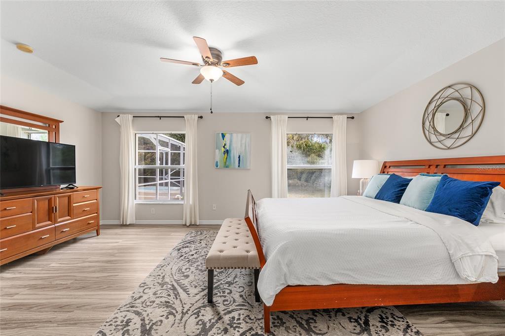 5248 Northwest 82nd Court Ocala, FL 34482 - Photo 31 of 73 a bedroom with a bed and wooden floor