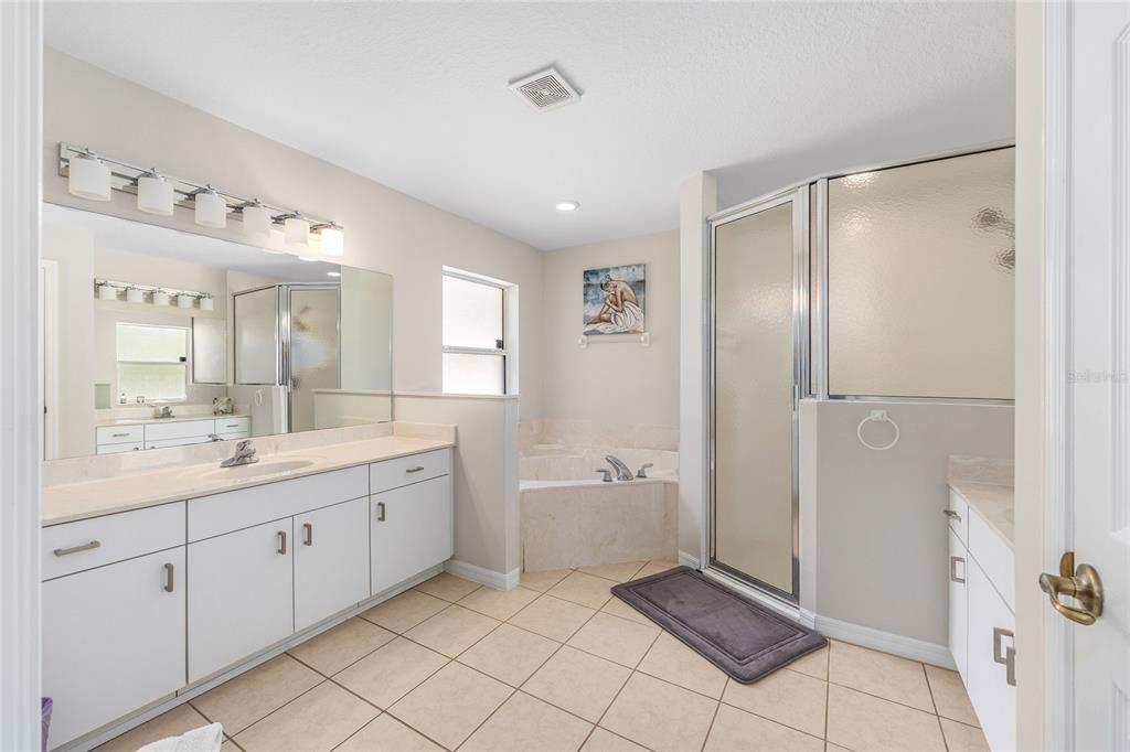 5248 Northwest 82nd Court Ocala, FL 34482 - Photo 32 of 73 a spacious bathroom with a double vanity sink a mirror and a bathtub