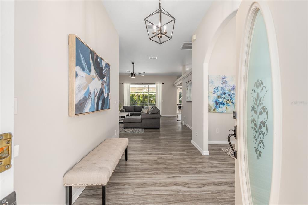 5248 Northwest 82nd Court Ocala, FL 34482 - Photo 10 of 73 a living room with furniture and a chandelier