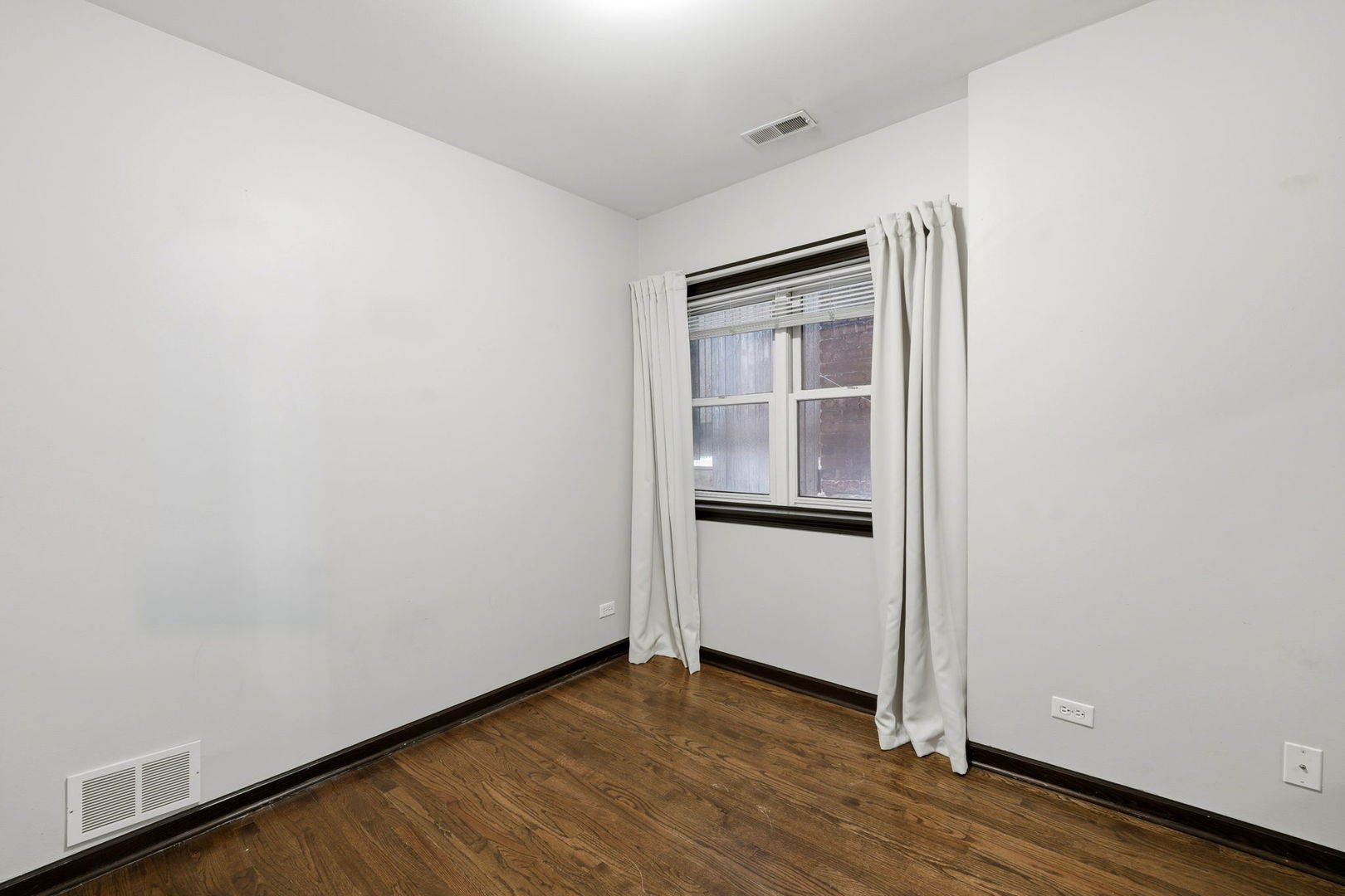 619 North Racine Avenue, Unit 1 Chicago, IL 60642 - Photo 23 of 36 a view of an empty room with wooden floor