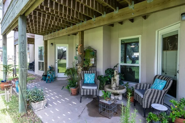 a view of patio with a chairs and table in a patio