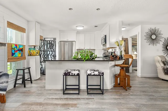 a view of living room filled with furniture and wooden floor
